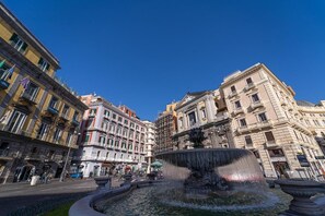 A historic square with a central fountain, surrounded by classical architecture and pedestrian pathways. - Le 4 Stagioni Dante H Napoli Centro by ClaPa Group Dislocated Hospitality (Naples)