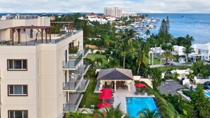 A hotel with multiple balconies, a pool area, and a view of the ocean and marina. - Luxury Condo with spectacular amenities on Paradise Island (Paradise Island, Nassau)