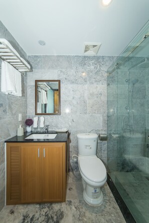 Deluxe dubbelrum - utsikt mot poolen | Badrum | Dusch, gratis toalettartiklar, hårtork och tofflor