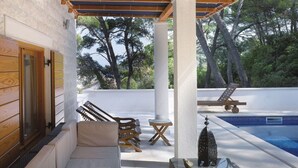 A rooftop terrace with a pool, lounge chairs, and a sun lounger. - LUXURY: VILLA on the SEA, POOL & BEACH BIKE & KAYAK & PRESENT (Rogac)