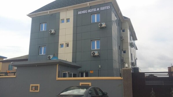 A multi-story building with the sign "DEMEG HOTEL & SUITES" at the top. - Demeg Hotel And Suites (Lagos)