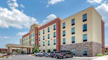 A multi-story hotel with a brick facade and a stone accent wall.