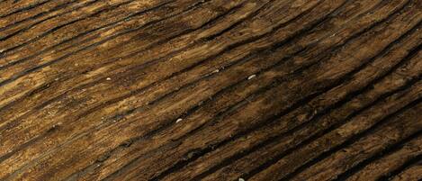 A close-up of a wooden surface with concentric curved lines.