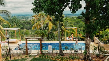 Outdoor pool, open 9:00 AM to 10:00 PM, pool umbrellas