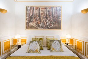 A hotel room with a large bed, two bedside tables, and a painting above the bed. - ***** THE IMPERIAL SUITE ***** (Roma)