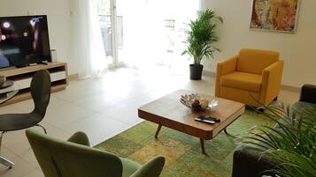 Design Apartment, 1 Bedroom, Lake View | Living room | 55-inch flat-screen TV with cable channels, Smart TV, pay movies