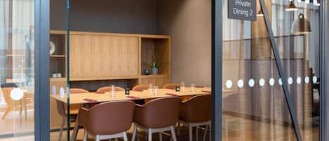 A private dining area with a wooden table, brown chairs, and a sign indicating "Private Dining 2".