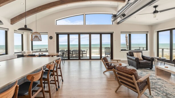 A spacious living area with a large open kitchen, dining area, and a view of the beach. - New! Pool! Sleeps 14, Sol de Mar Beach, huge views, modern, duplex unit A (Carolina Beach)