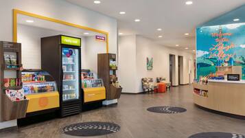 A hotel lobby with a 'really cold' beverage machine, a 'cool it' sign, and a 'Welcome to the Lehigh Valley' mural.