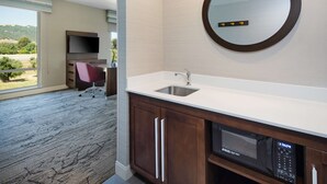 A modern bathroom with a sink, mirror, and microwave. - Hampton Inn & Suites Gilroy (Gilroy)