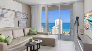 A modern living room with a large window offering a view of the ocean and cityscape.