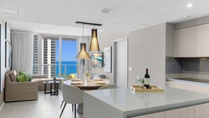 A modern apartment with a kitchen, dining area, and living room.