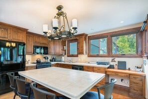 Enjoy cooking in this well-equipped kitchen with a large island, stove, and dishwasher.