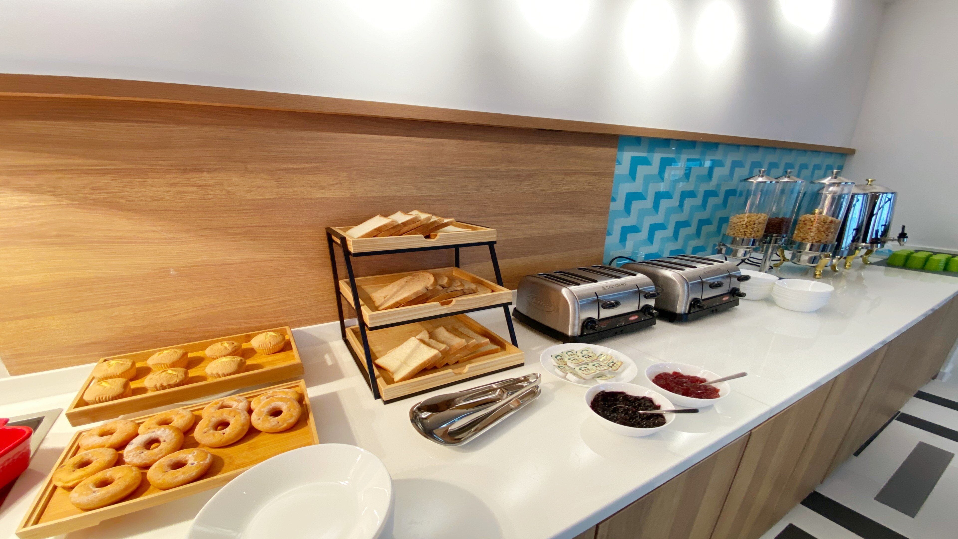 A breakfast buffet with various food items and a coffee station.