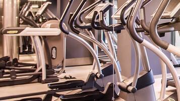A row of stationary bikes in a gym.