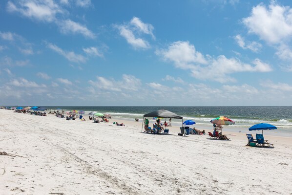 Enjoy a serene beach experience with umbrellas and comfortable seating.