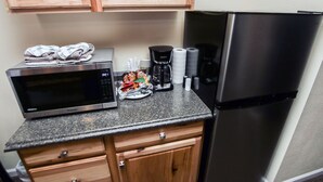 A kitchenette with a microwave, coffee maker, and refrigerator. - Fawn Valley Inn: 293 (Estes Park)