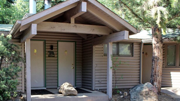 A cabin with a porch, two doors, and a chimney. - Sunnyside Knoll: 4 (Estes Park)
