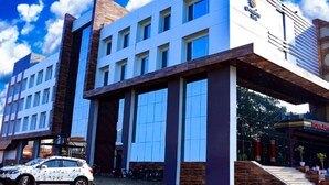 A modern hotel with a prominent white facade, large windows, and a visible Comfort Inn logo.