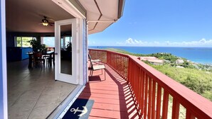 A balcony with a red railing overlooking a coastal view. - Breathtaking Panoramic Views Of The Caribbean Sea From This Luxury Villa (St. Thomas)