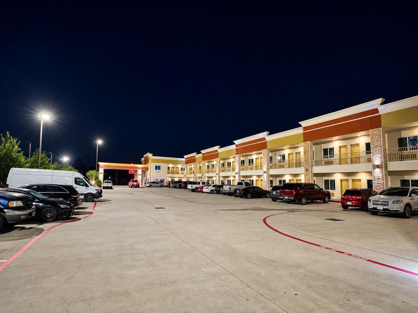 A multi-story hotel with a parking lot.