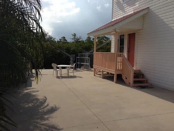 Enjoy outdoor dining or relaxation on the porch with a small table and two chairs.
