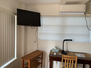 Enjoy a functional space with a flat-screen TV, desk, and air conditioning for a comfortable stay.