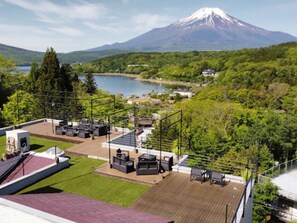 Une terrasse sur le toit, avec des sièges en plein air et une vue sur une montagne.