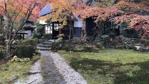 A traditional Japanese-style building with a stone pathway leading to the entrance. - WOOD DESIGN PARK - Campground (Okazaki)