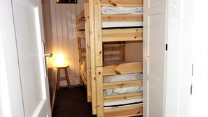 A narrow hallway with wooden bunk beds and a small stool with a light. - Magrappé M 544 - SKI LIFT studio 4 pers (Veysonnaz)