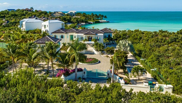 A resort with multiple buildings, a pool, and a beach view. - Exclusive Oceanfront Villa On Taylor Bay Beach! (Providenciales)