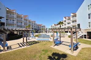 Guests can enjoy a resort-style stay with access to a covered patio featuring seating and a small fountain.
