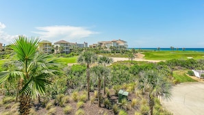A golf course with a view of ocean and multiple houses. - CB334 Romantic & Family Ocean & Golf Views - & bring your pet too! (Palm Coast)