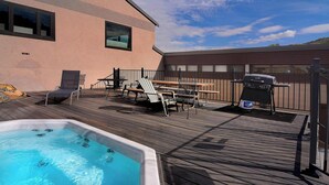 A swimming pool with lounge chairs and a barbecue grill on a wooden deck. - Snowcrest, Hot tub!  Walk to lifts! (Mt. Crested Butte)