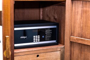 A black electronic device with a keypad and operating instructions in a wooden cabinet. - Macalister Terraces Hotel (George Town)