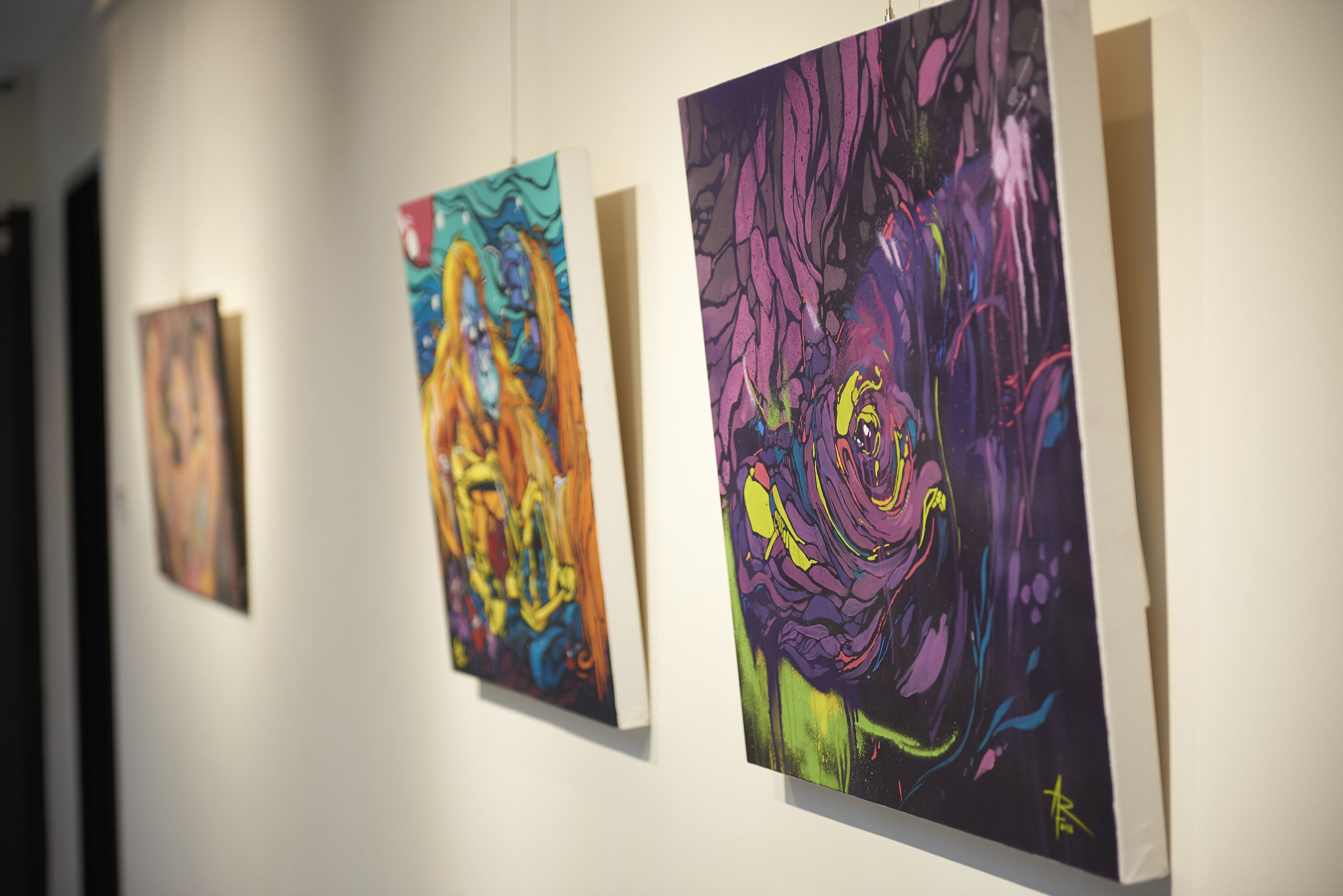 A gallery with artworks displayed on the wall.