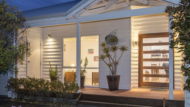 A modern house with a covered porch, potted plants, and a display cabinet. - Burnvale: spacious family home, 500m to beach, air-conditioned (Dunsborough)