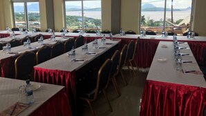A conference room with long tables, chairs, and water bottles. - Villa Rosa Mystica Hotel (Homa Bay)
