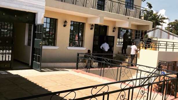A two-story building with a balcony, large windows, and a tiled entrance area. - Villa Rosa Mystica Hotel (Homa Bay)