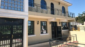 A two-story building with a balcony, large windows, and a gated entrance. - Villa Rosa Mystica Hotel (Homa Bay)