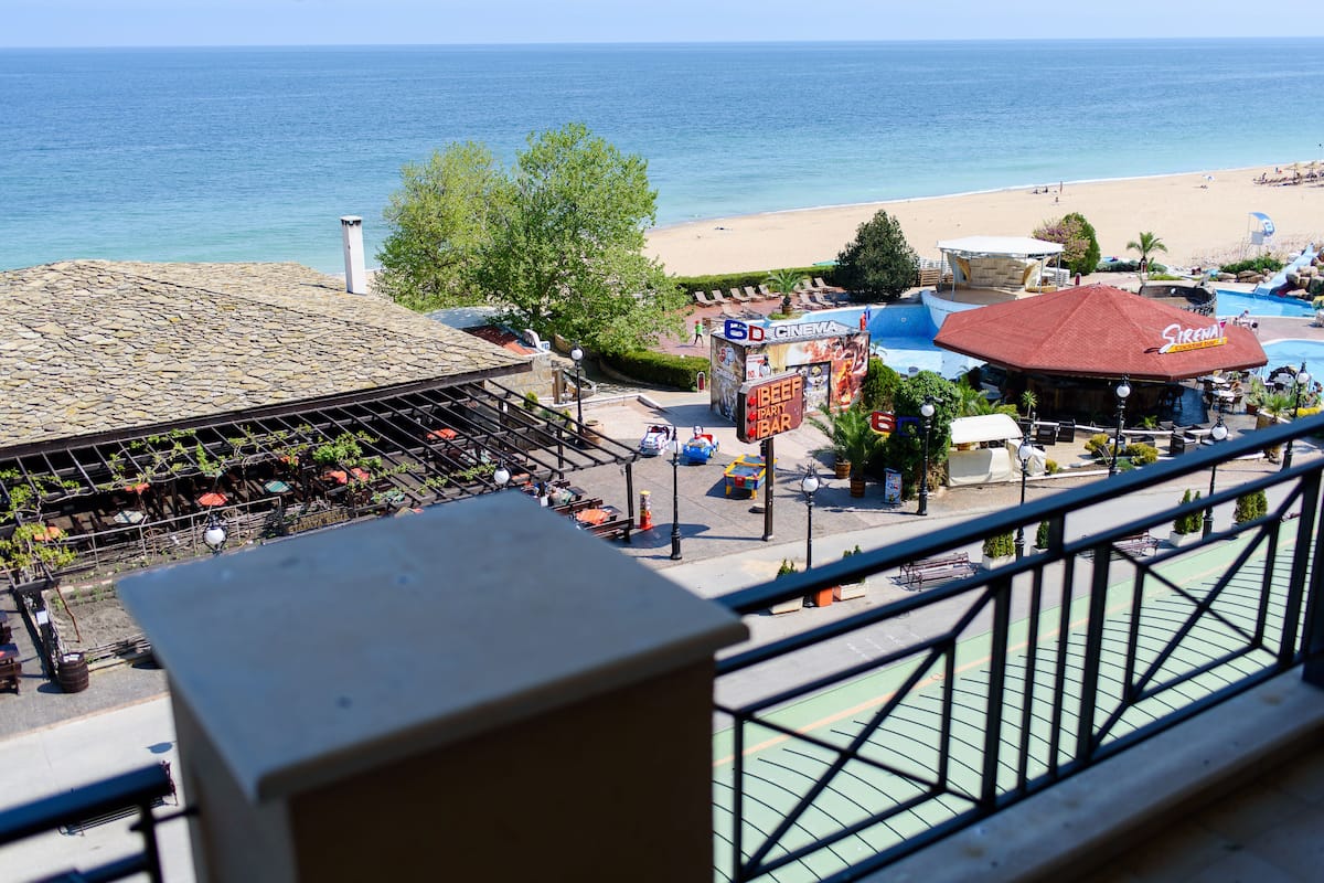 A beachside view with a cinema, a barbecue restaurant, and a pool area.