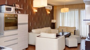 A compact living space with a kitchenette, a sofa set, and a dining table. - Sea View Rental Front Beach (Golden Sands)