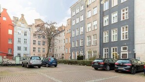 A parking area with several cars and a bicycle.