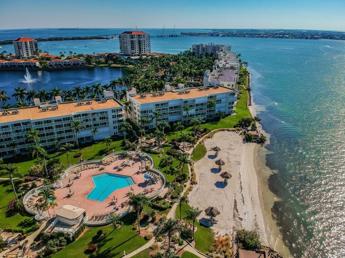 A resort with a pool, beach, and ocean view.