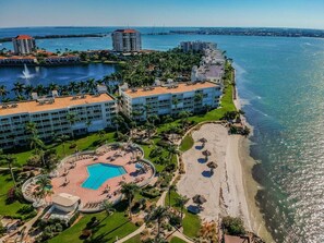 A resort with a pool, beach, and ocean view.