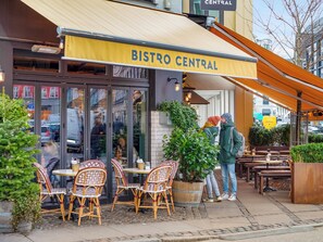 Enjoy meals in a charming outdoor setting with wicker chairs and tables.
