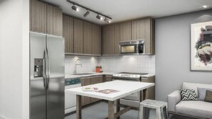 A modern kitchen with stainless steel appliances, wooden cabinets, and a white countertop. - Sentral Wynwood (Miami)