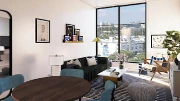 A modern living room with a large window, a sofa, a coffee table, and a dining table.