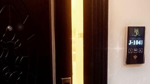 A hotel room entrance with a modern door, a digital keycard reader, and a room number sign. - The 58 Hotel Mahboula (Mahboula)