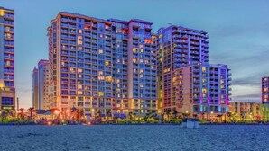 A high-rise hotel with multiple balconies, a beachside location, and a well-lit facade. - OBC - 2BR/2BA Suite - City View - Multiple Pools and Amenities! (Virginia Beach)